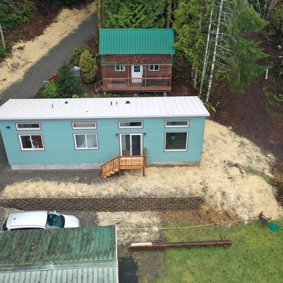 Aerial shot of a green and grey Wolf Model F home