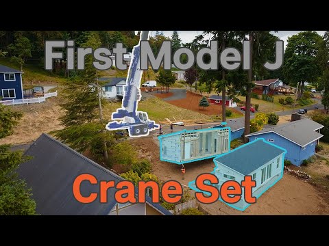 Crane sets a home on a steep waterfront lot