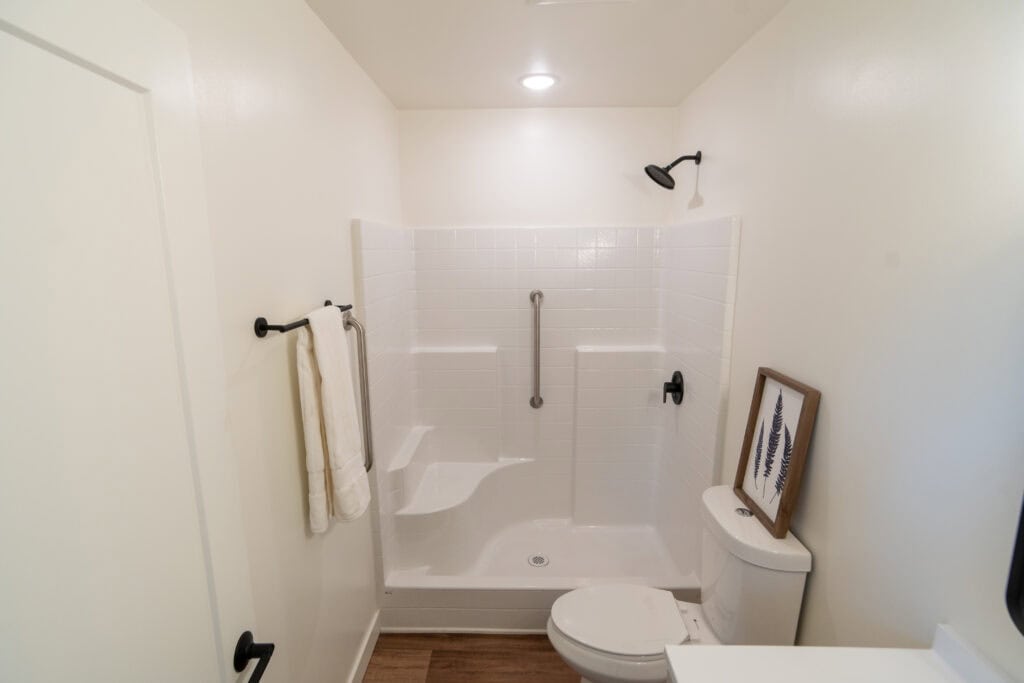 Shower with grab bars in a Wolf Model F home at Orchards District Cottages