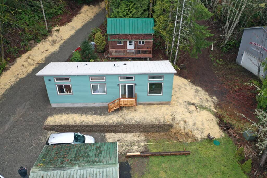 Aerial shot of a green and grey Wolf Model F home