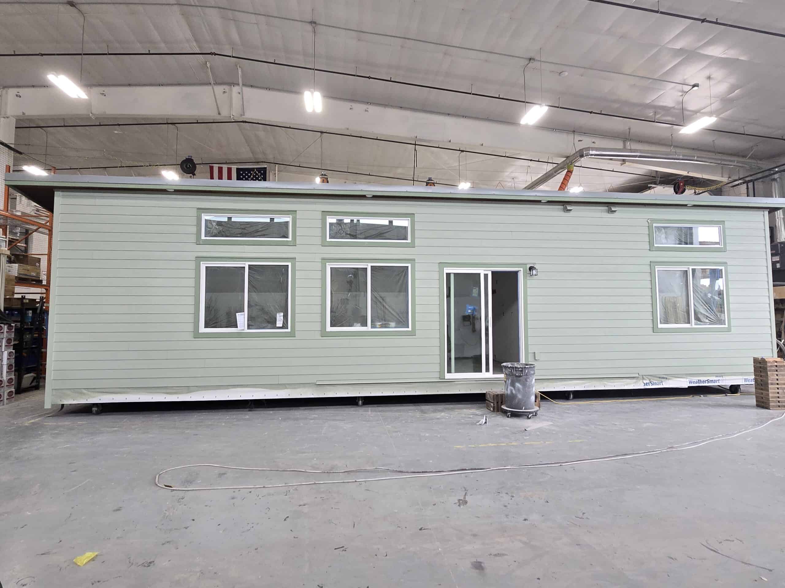 A light green Wolf Model E home getting the finishing touches put on in the Wolf shop.