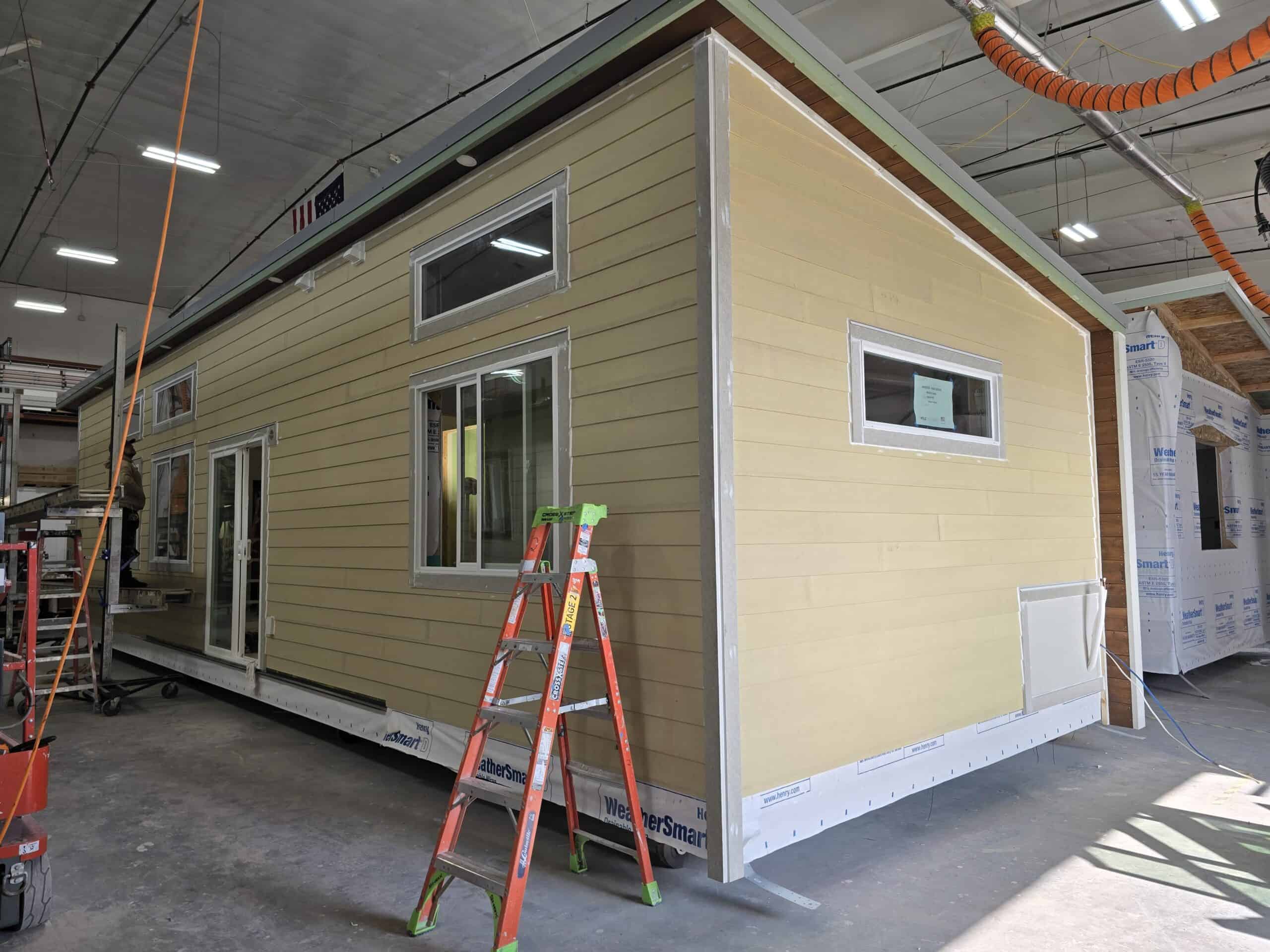 Wolf Model E home in process of being caulked after siding installation.