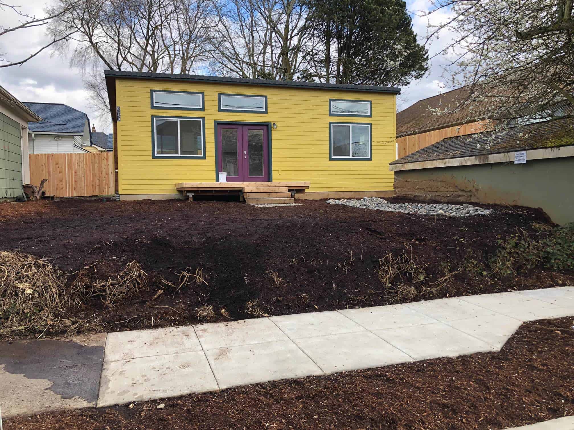 Yellow and black Wolf Model G home with purple French doors.