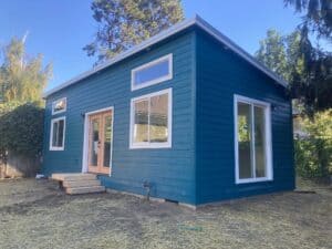 Green Wolf Model G home with peach French doors.