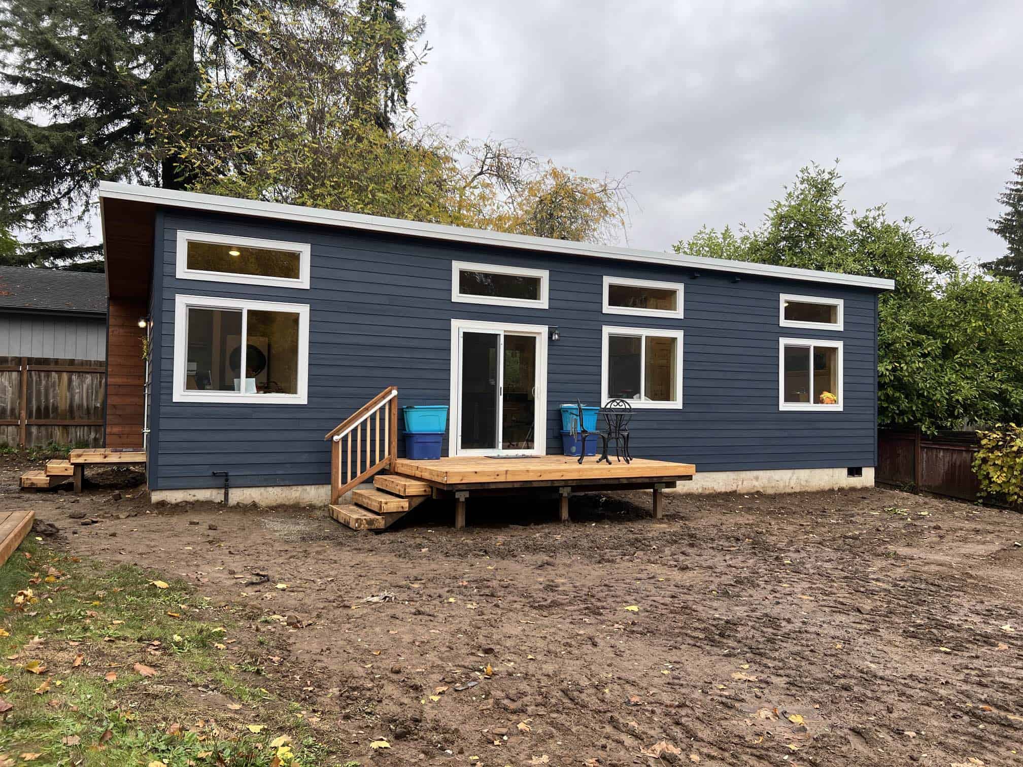 Blue and white Model E Wolf home with deck and sliding glass door.
