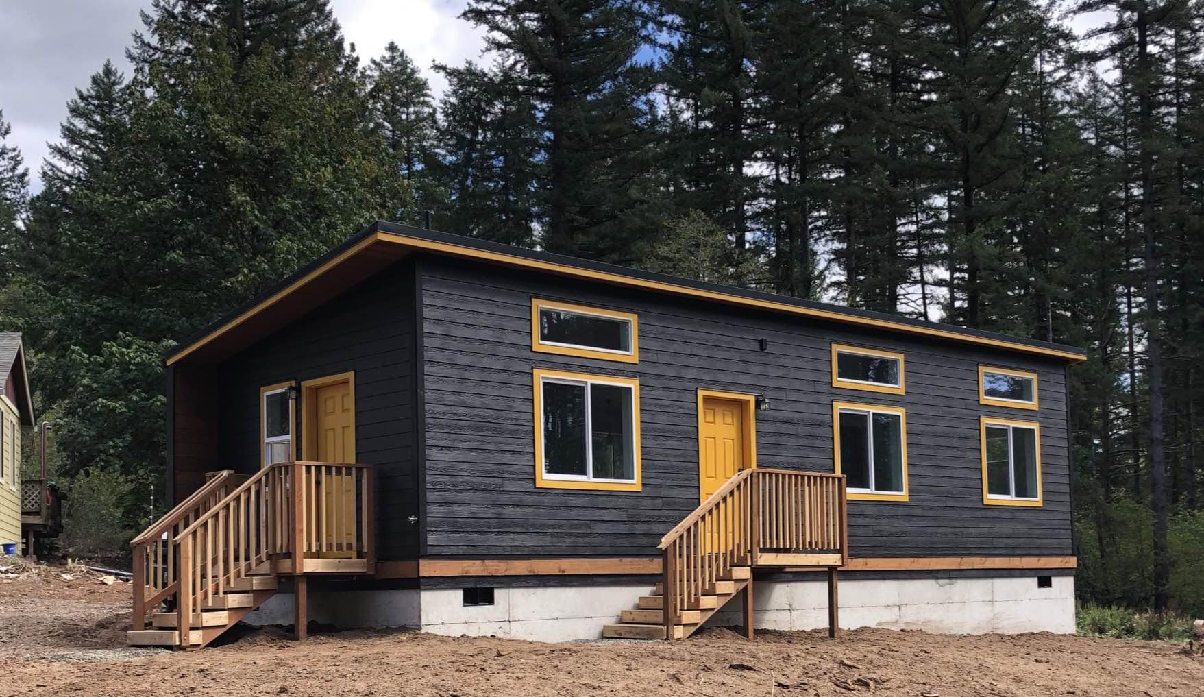 Black and yellow Wolf Model E home with custom stem wall foundation.