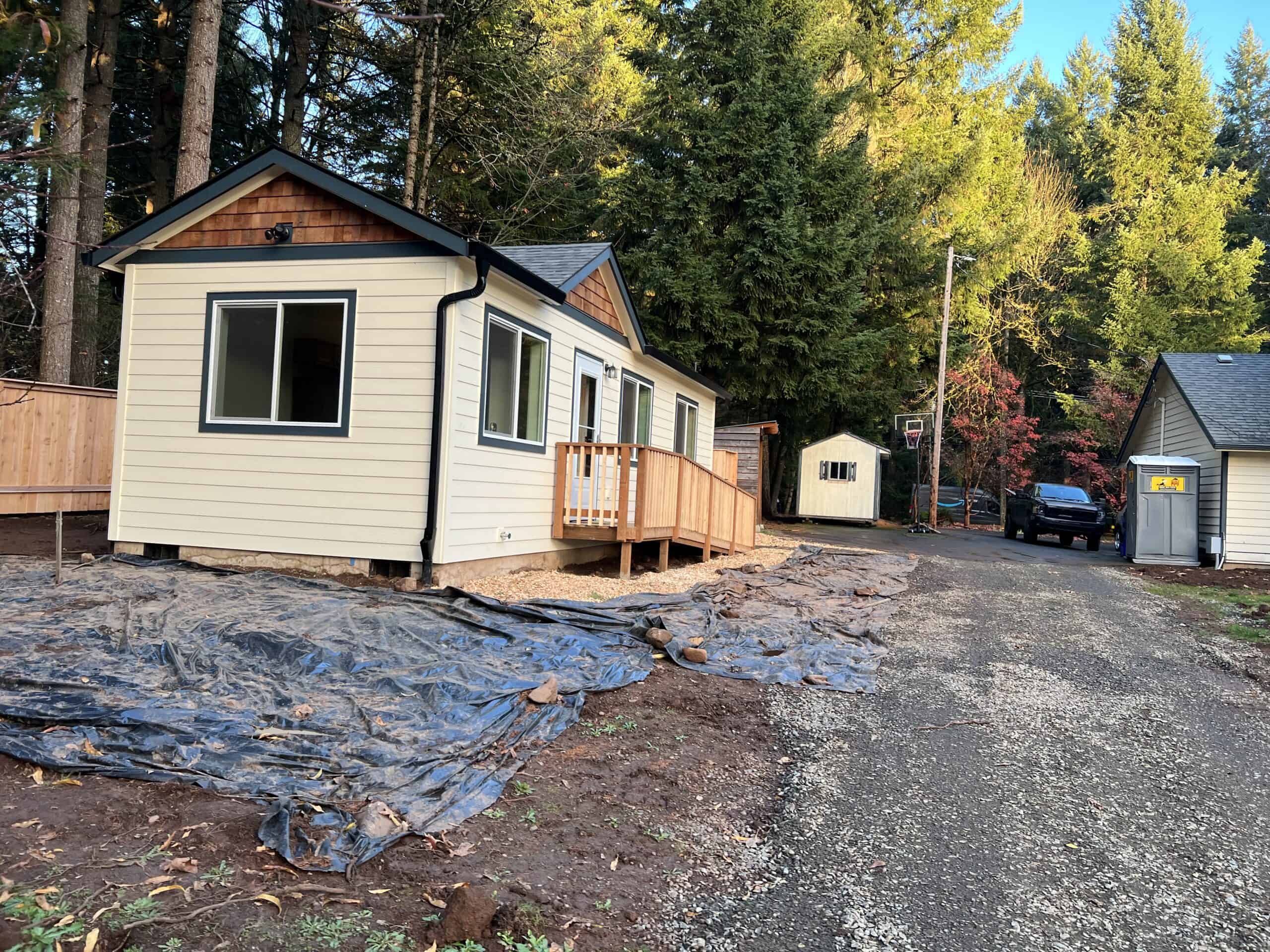 Cream and black Wolf Model K home with gable cedar shakes and ramp entry.