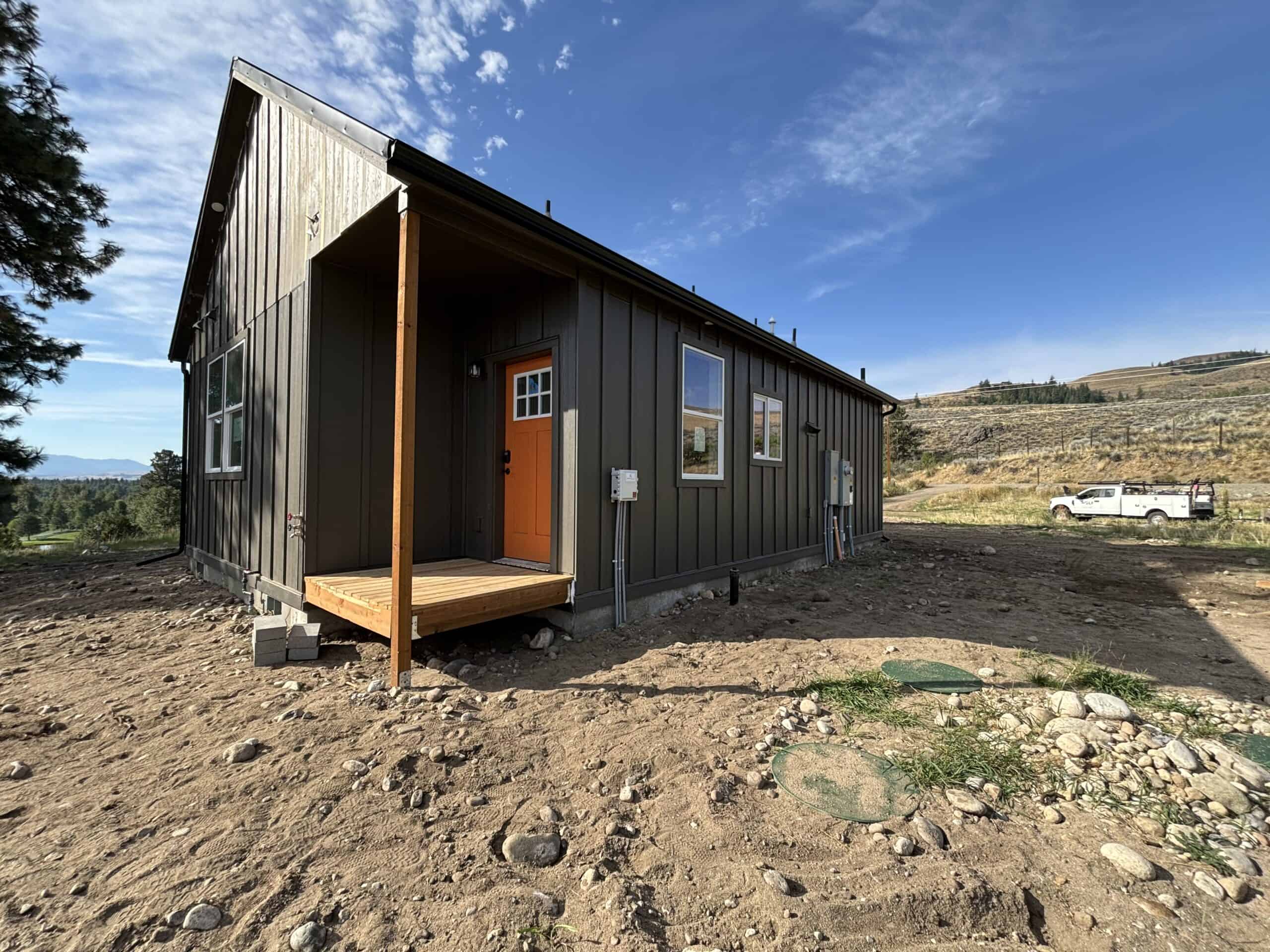 Black Wolf Model J home with orange door.
