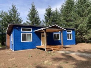 Blue Wolf Model E home with shed roof and covered porch deck.