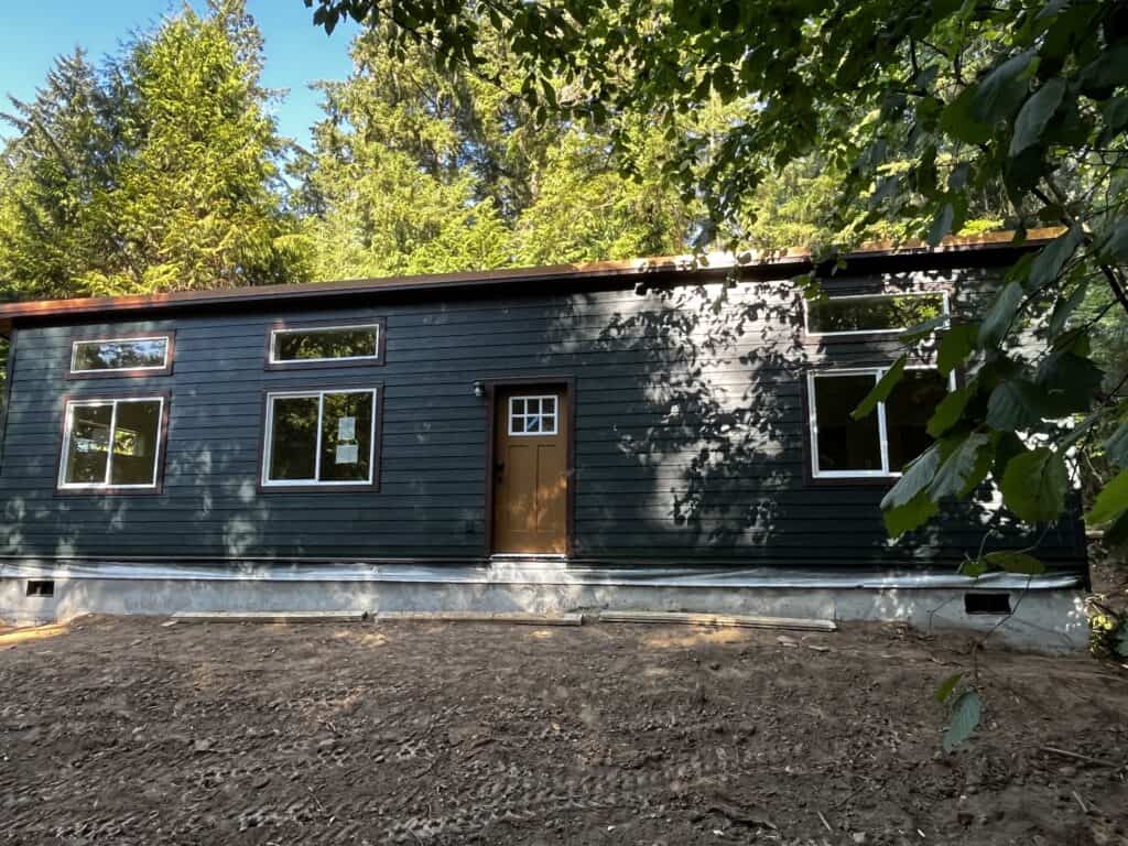 Dark green and brown Wolf Model E home with tan door.