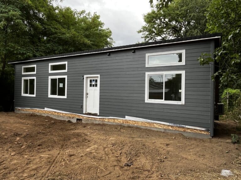 Gray and white Wolf Model E home with transom windows.