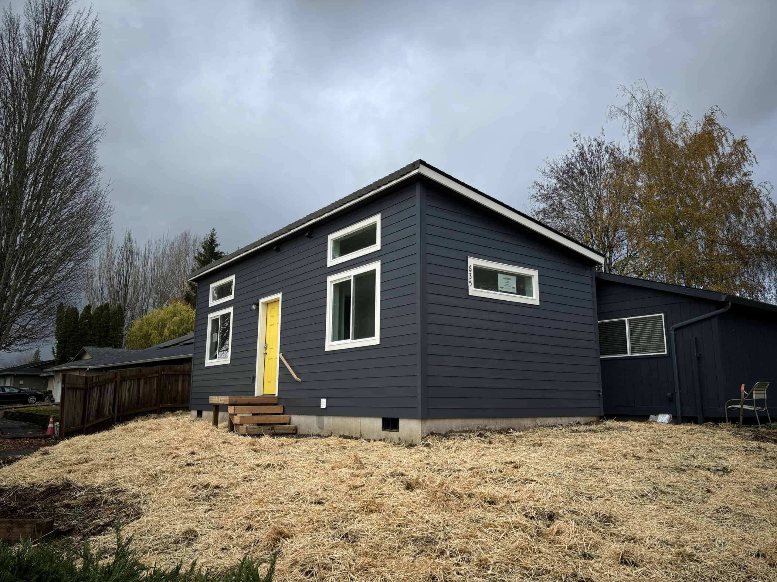 Wolf Model G home with shed shingle roof and transom windows.
