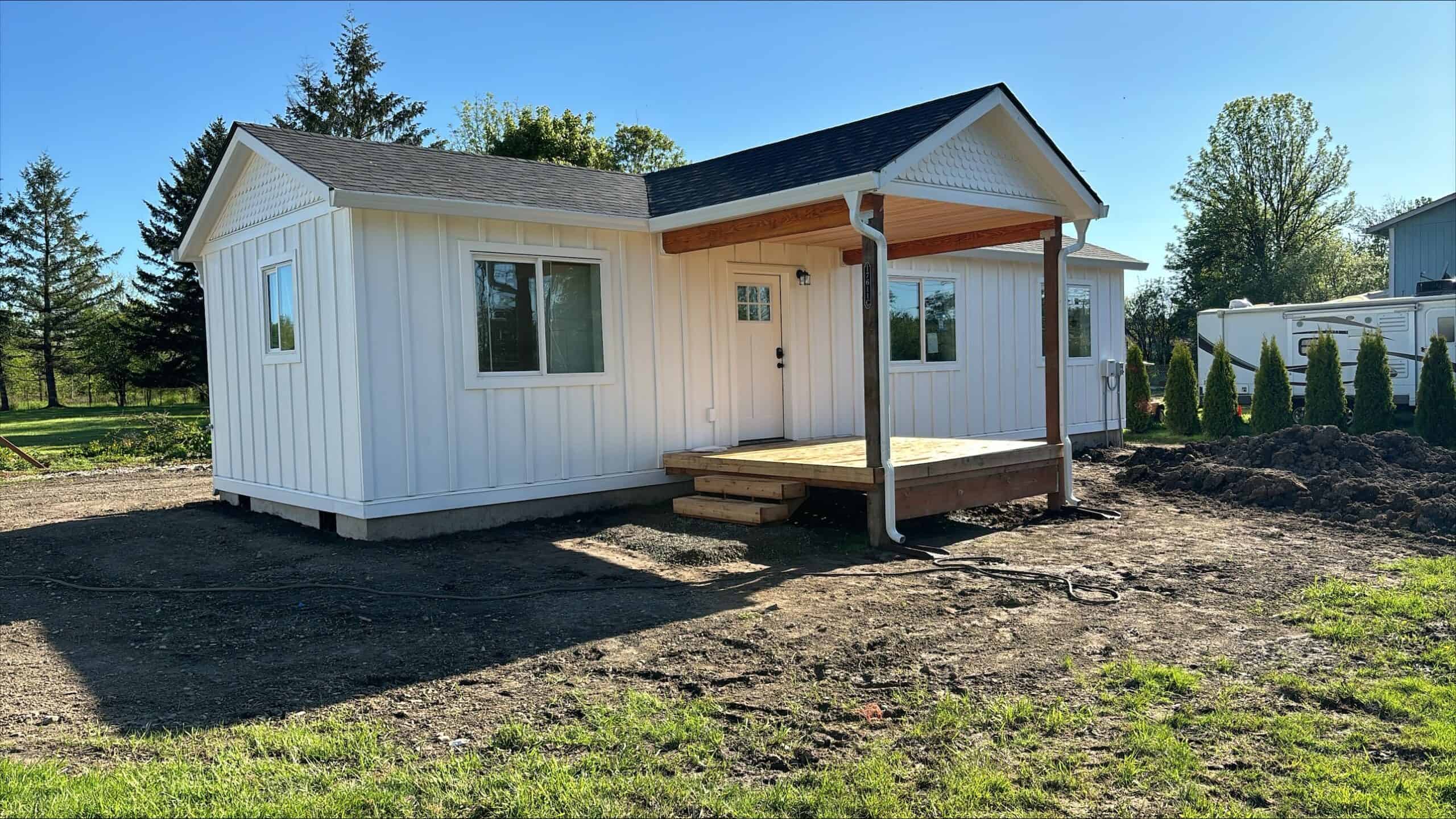 All-white Wolf Model E home with covered front deck porch.