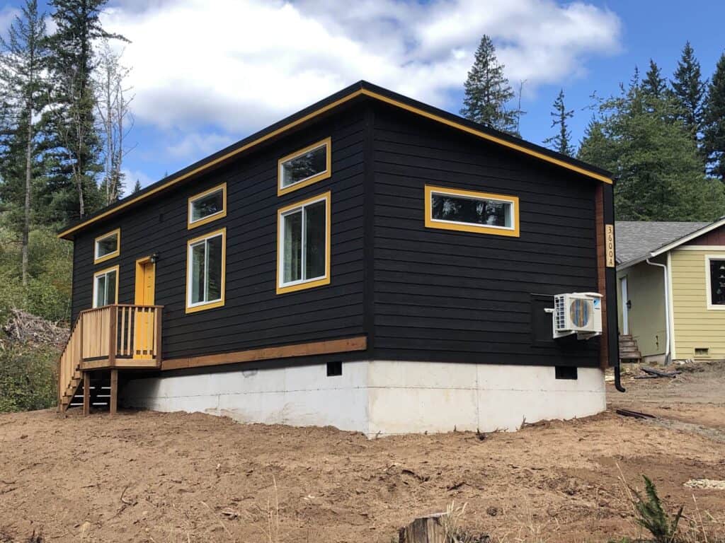 Black and yellow Wolf Model E home with transom windows.