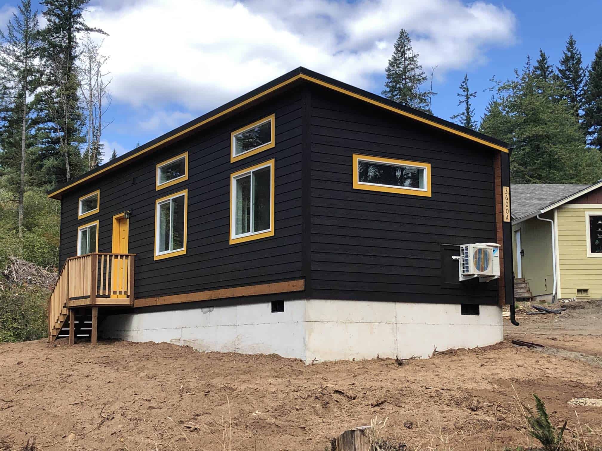 Black and yellow Wolf Model E home with transom windows.