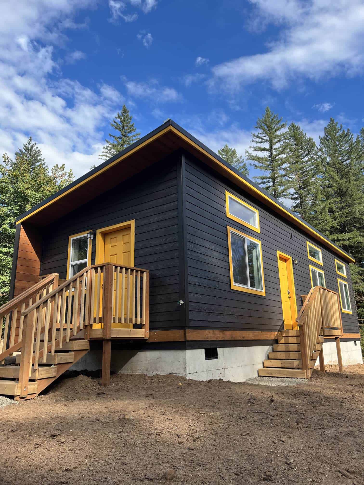Black and yellow Wolf Model E home with elevated stem wall foundation.