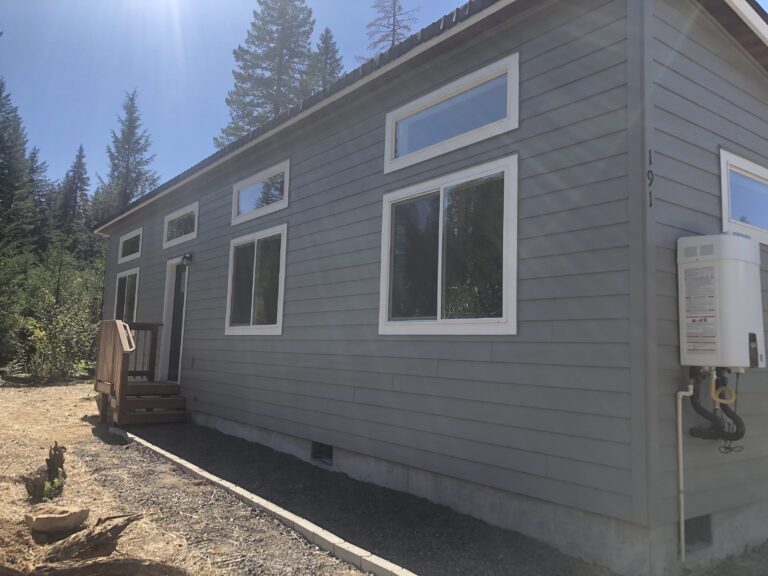 Grey and white Wolf Model E home with transom windows.