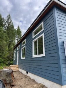 Green and white Wolf Model E home with transom windows.