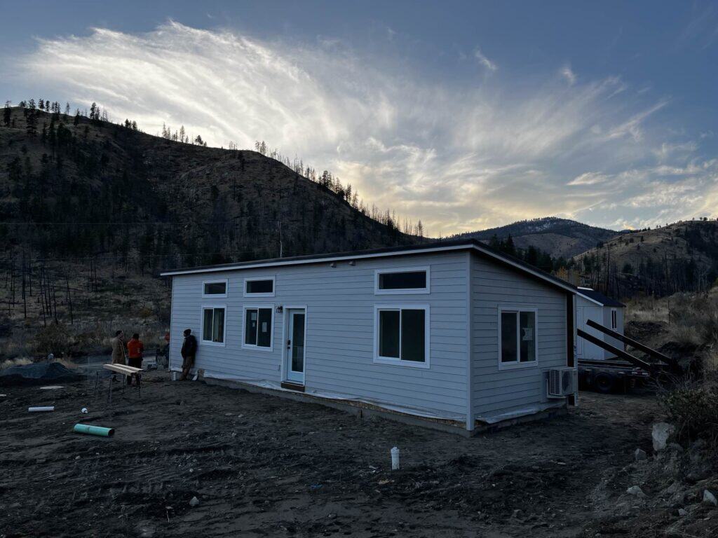 Grey and white Wolf Model E home with transom windows.