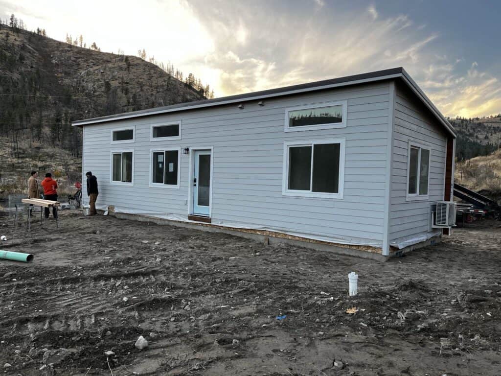 Grey and white Wolf Model E home with transom windows.
