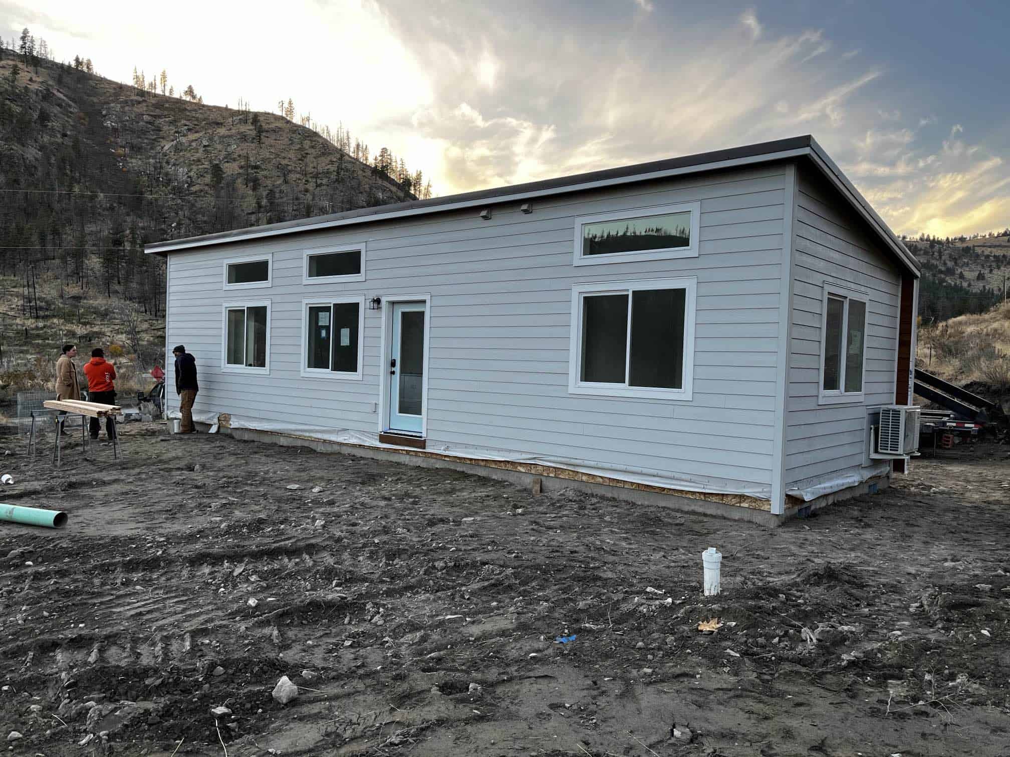 Grey and white Wolf Model E home with transom windows.