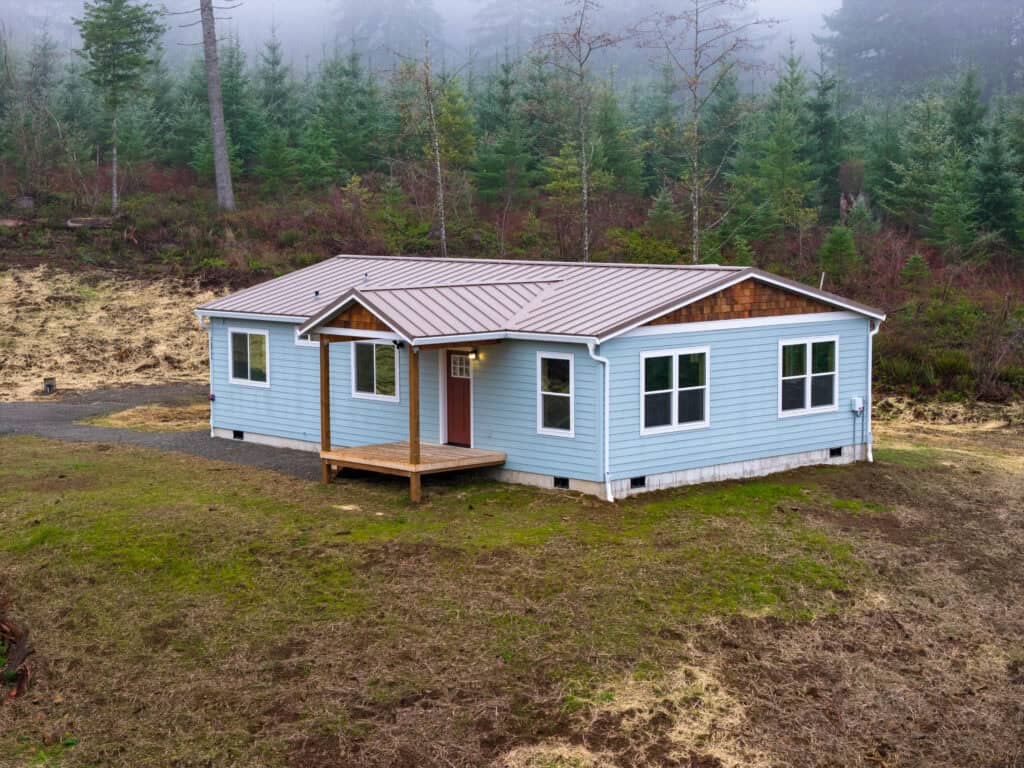 Wolf Model I home with metal gable roof and cedar shakes.