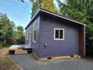 Blue and white Model E with exterior soffit lighting.