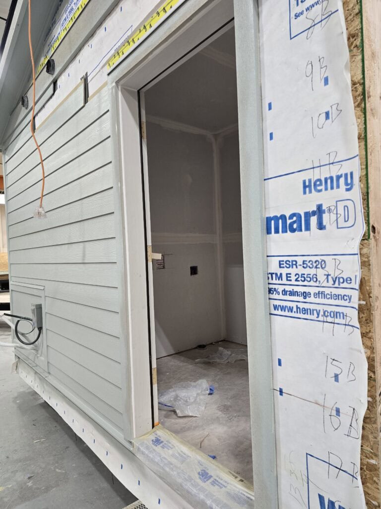 Unfinished entry doorway on a light gray Wolf Model L module in the shop.