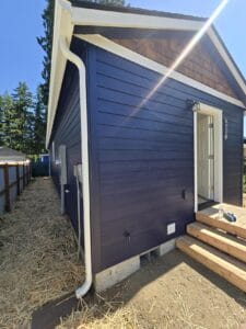 Blue and white Wolf Model E ADU with cedar shake gable.