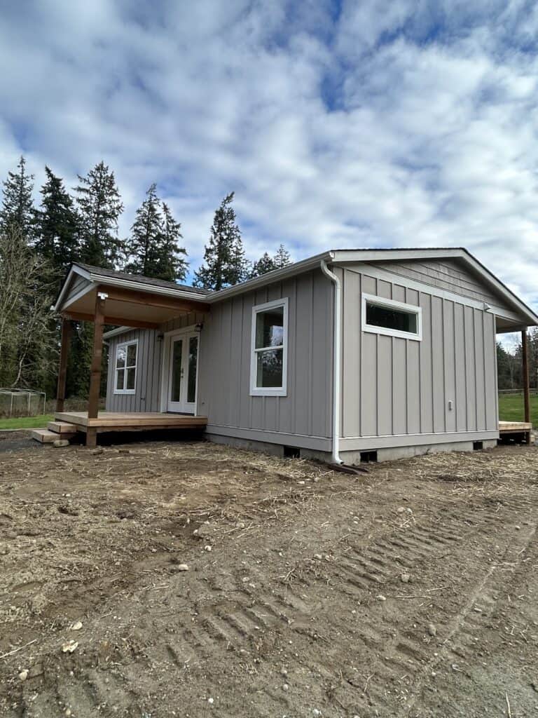 Wolf Model J on Bainbridge Island with a covered porch deck and board-and-batten siding