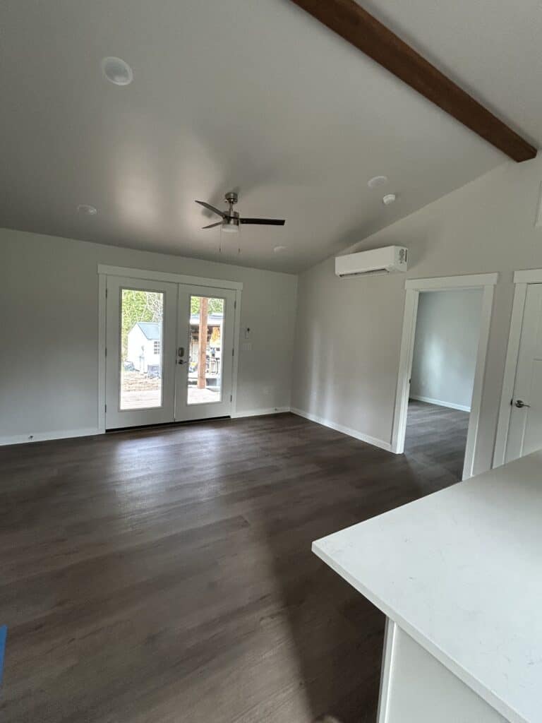 Open living area with French doors inside the Bainbridge Island Model J