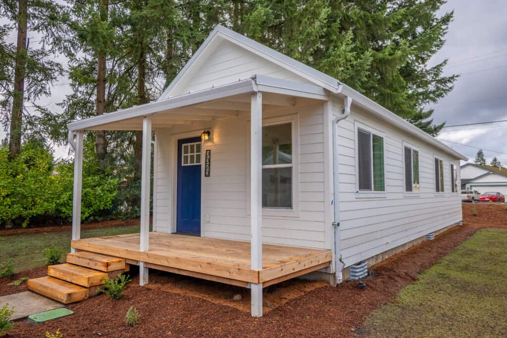 Model F Home at Orchards District Cottages with covered deck porch