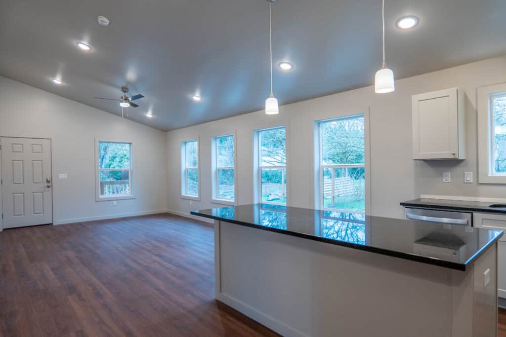 View into great room from kitchen in a Wolf Model L home.