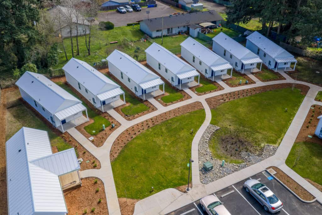Aerial view of 7 Wolf Model F and 1 Wolf Model E homes at Orchards District Cottages.