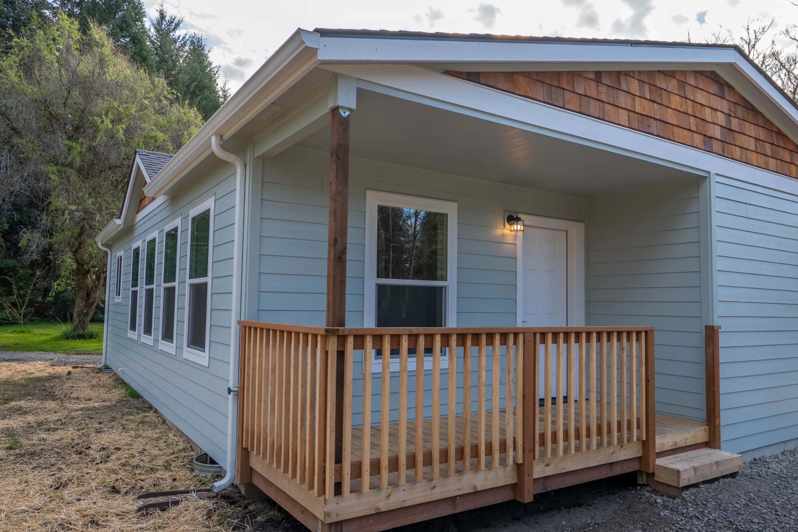Covered front porch deck and six windows on a Wolf Model L home.