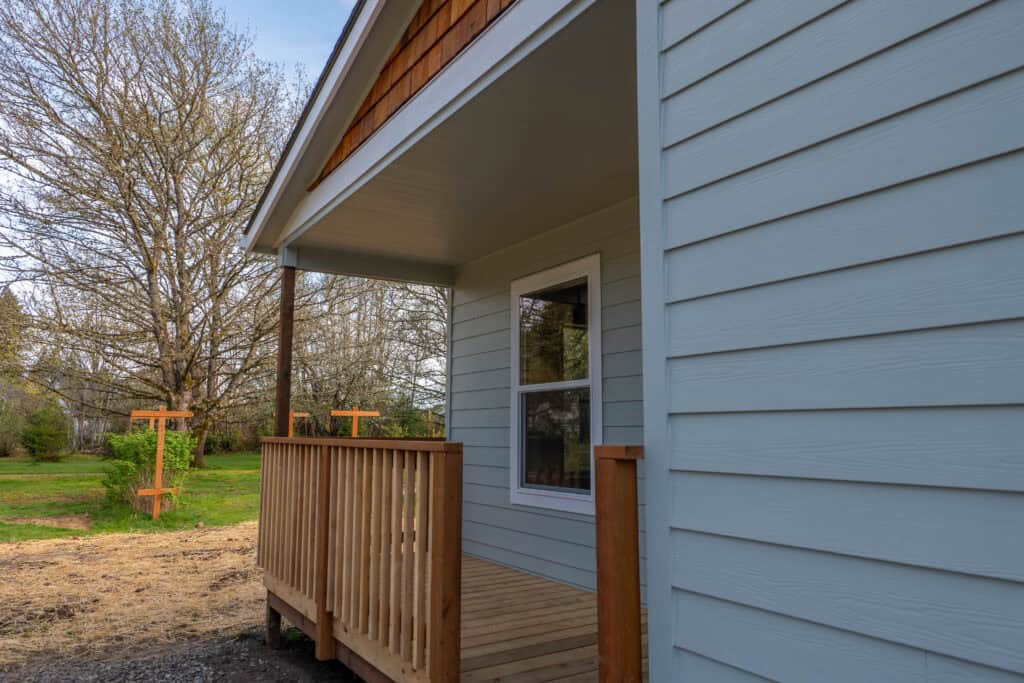 Front entry with covered porch deck on a Wolf Model L home.