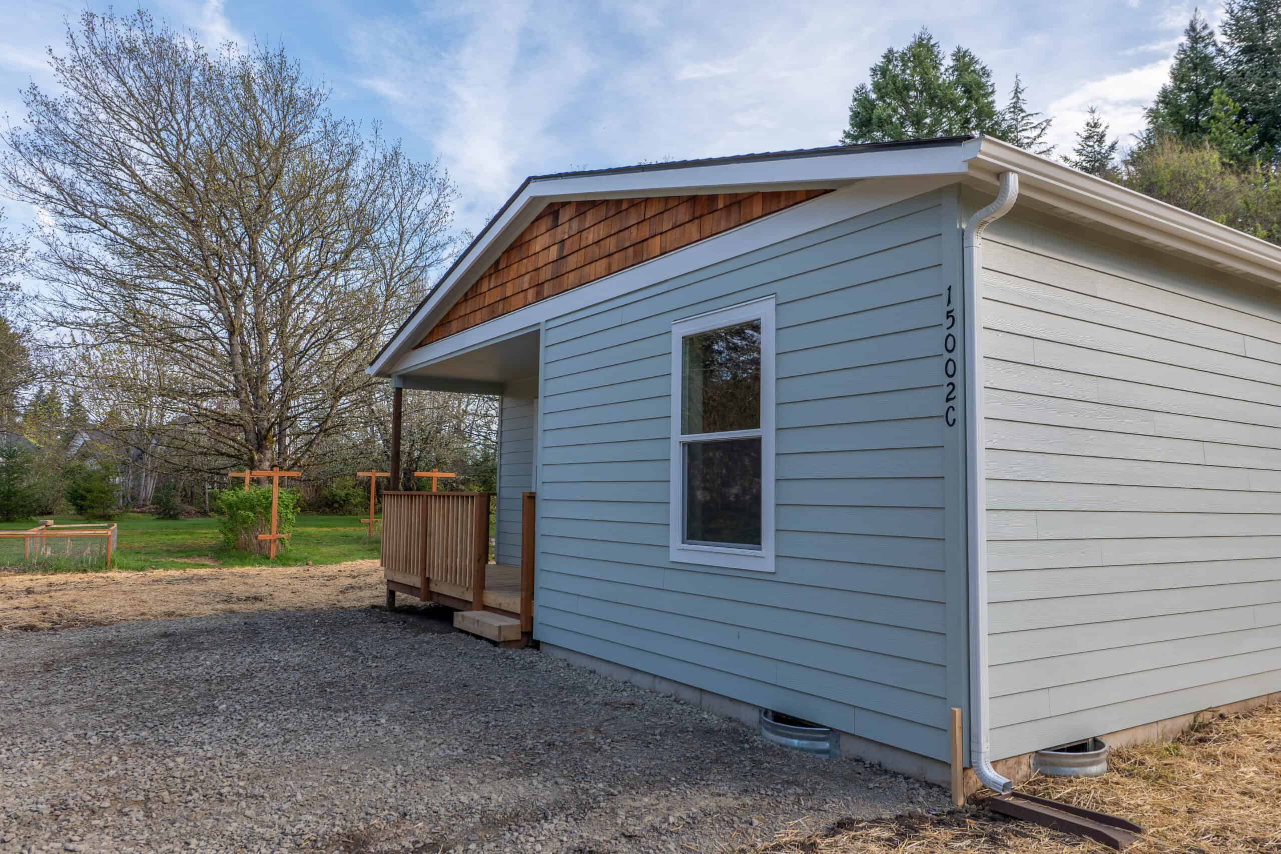 Wolf Model L home with built-in covered porch with deck.