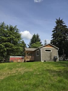 Wolf Model E home with ramped entry and cedar shake gables.