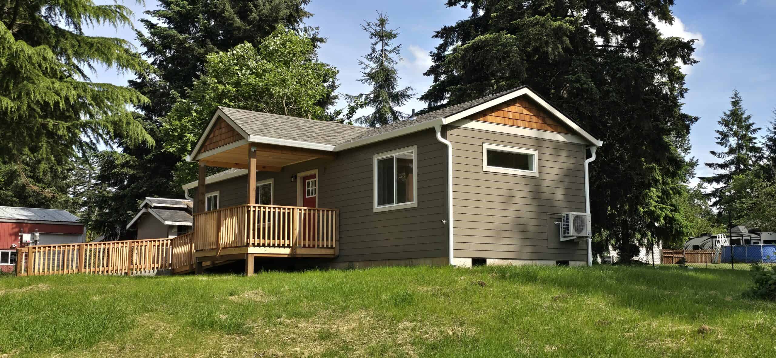 Wolf Model E home with l-shaped ramp entry and covered porch deck.