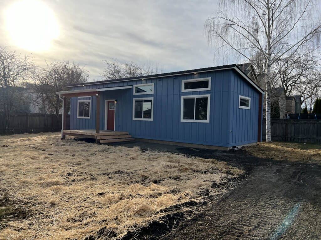 Blue and white Wolf Model E ADU with board and batten siding.
