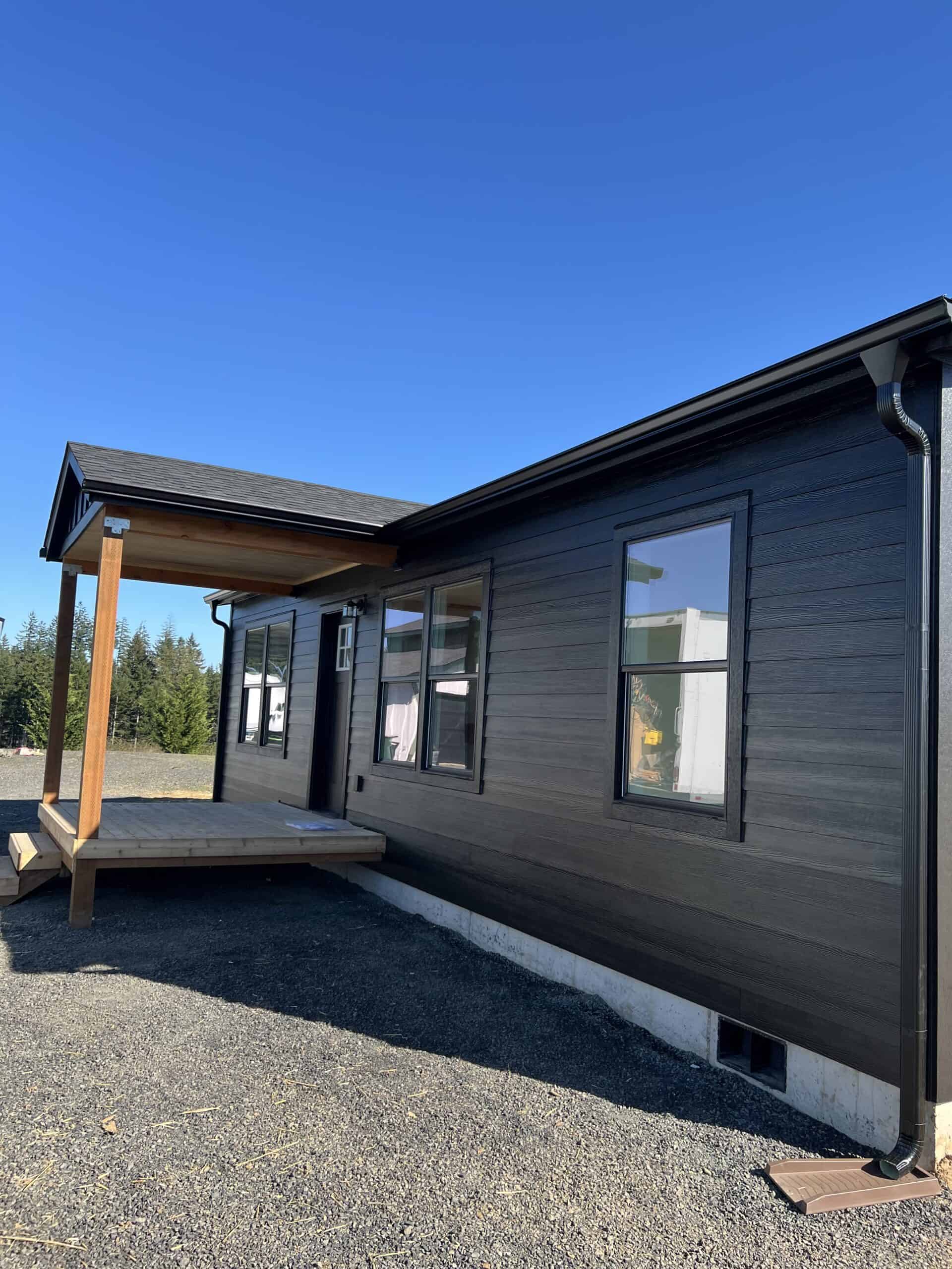 Covered entry on an all black Wolf Model J modular home in Chehalis WA