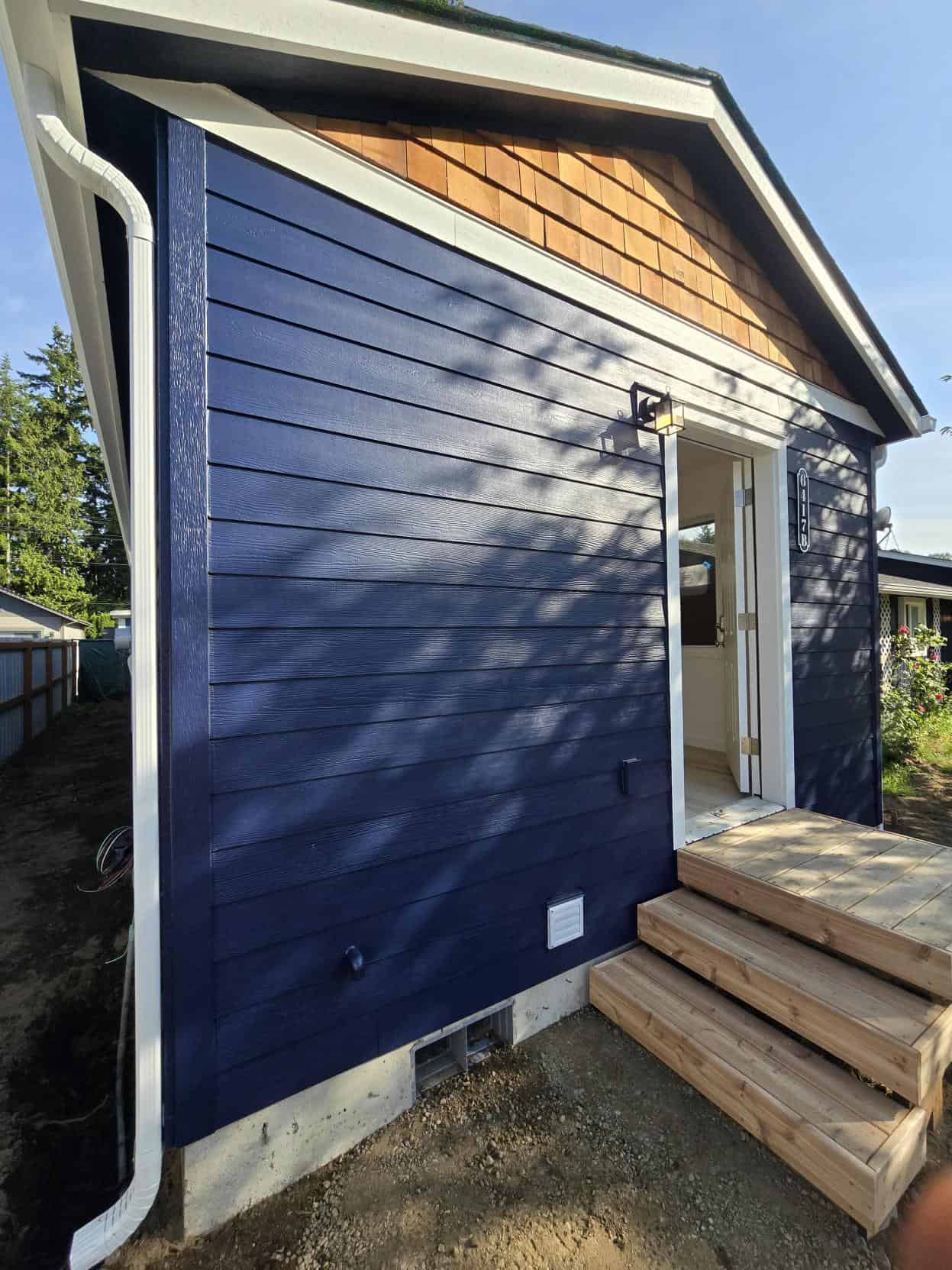Blue and white Wolf Model E ADU with cedar shake gable.