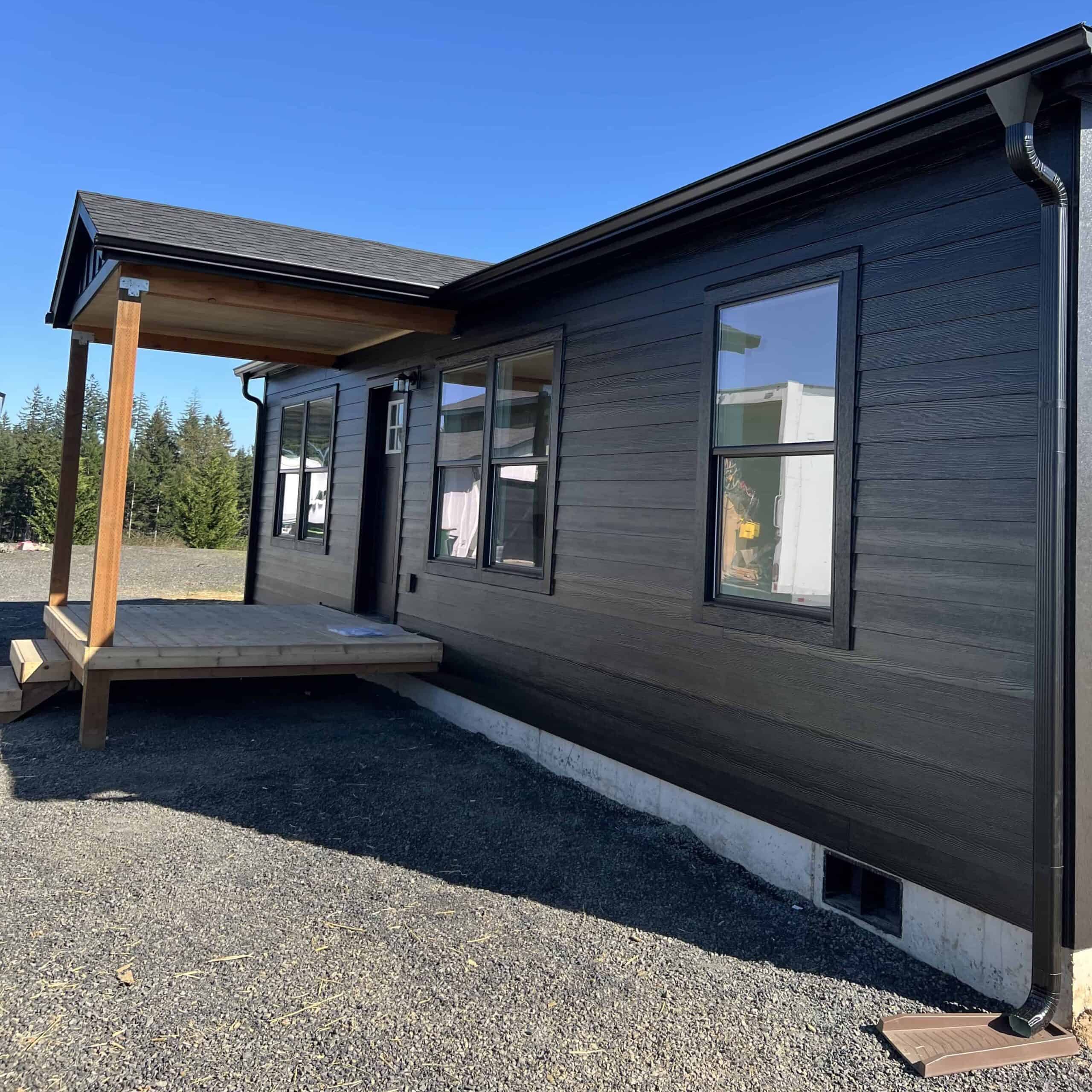 Covered entry on an all black Wolf Model J modular home in Chehalis WA